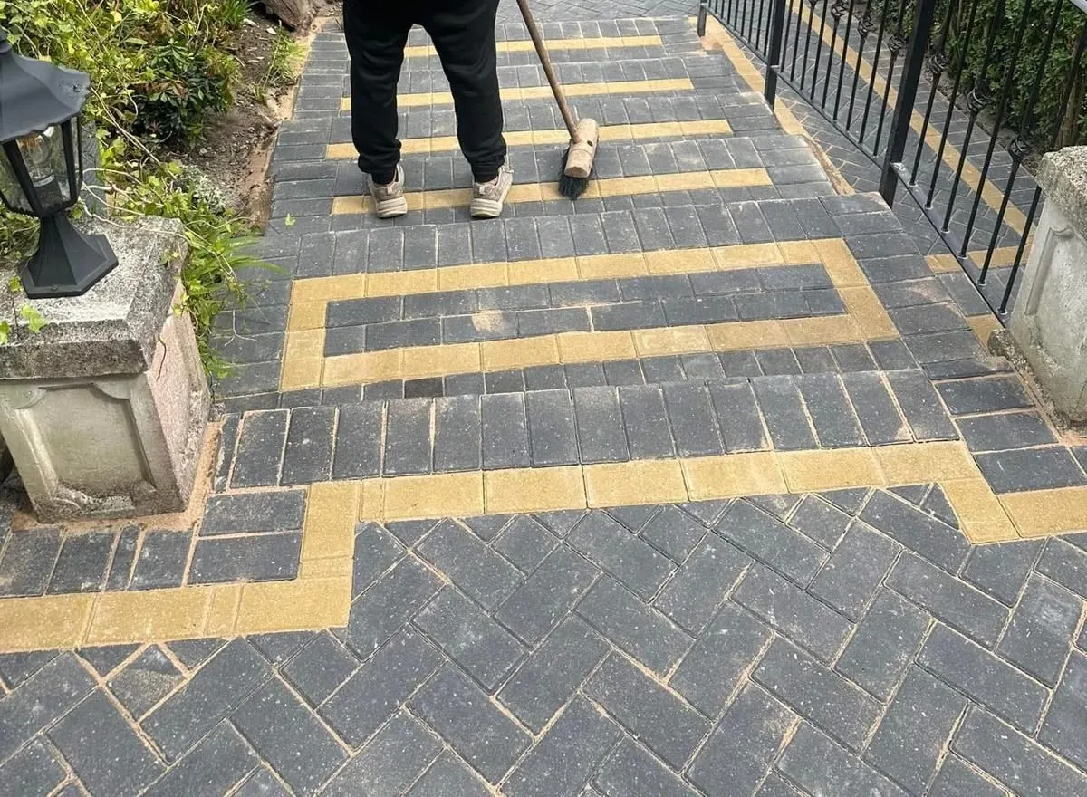 Block paved garden path being finished