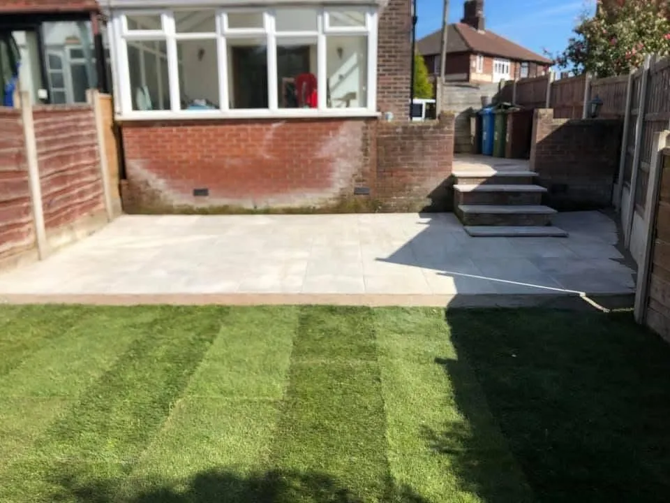 Sandstone patio and new turf behind a semi