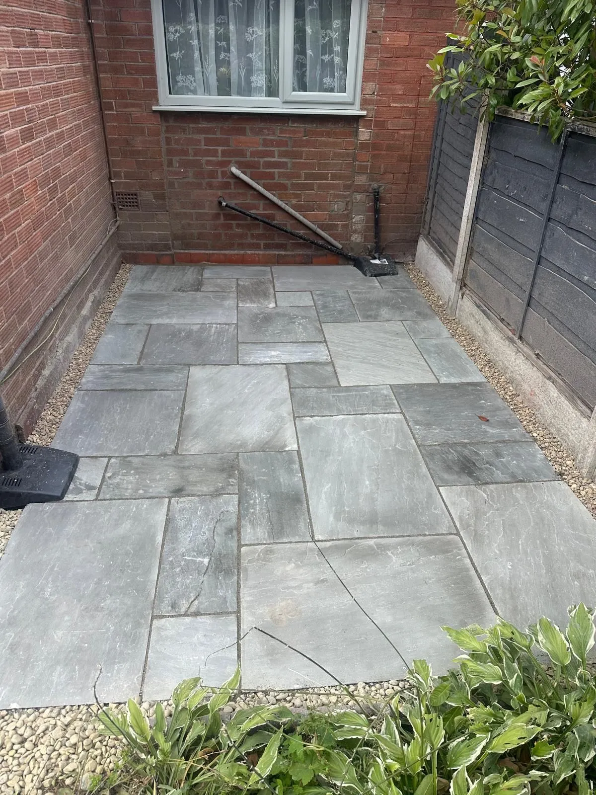 Grey sandstone patio in a walled yard