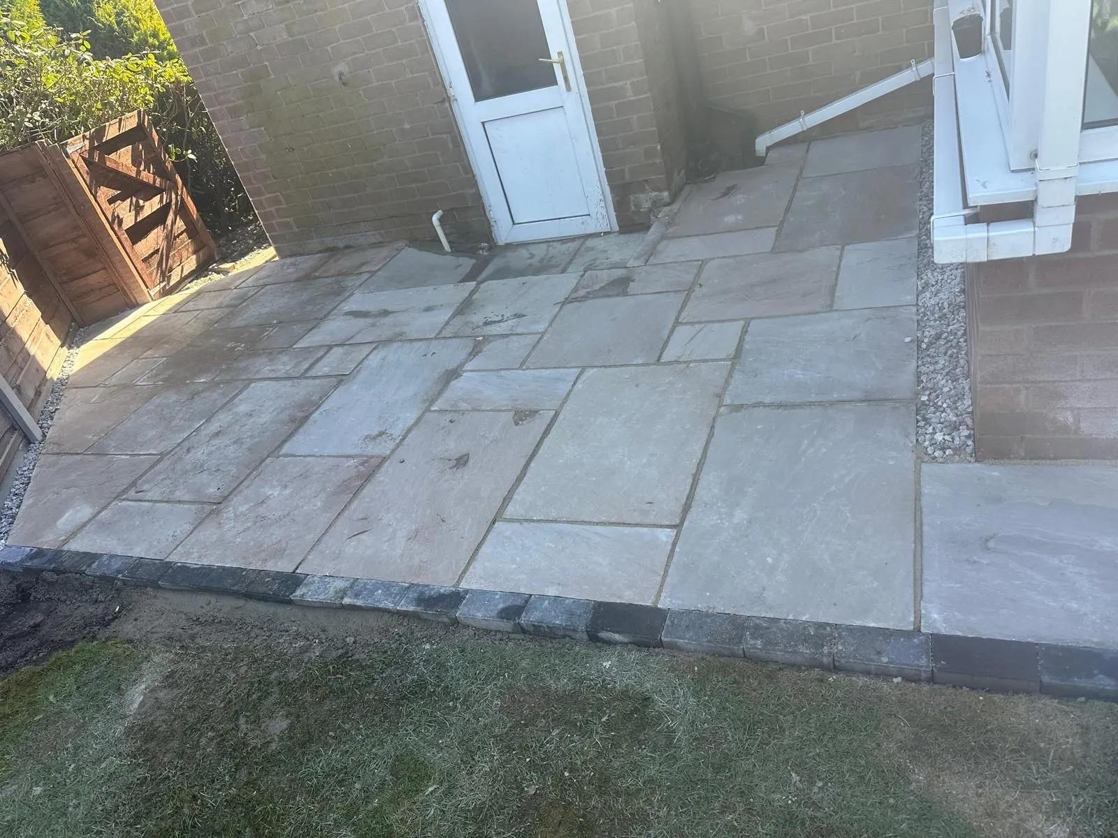Grey sandstone patio with a charcoal border