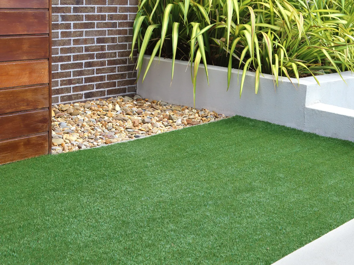 Artificial grass lawn beside a raised planter