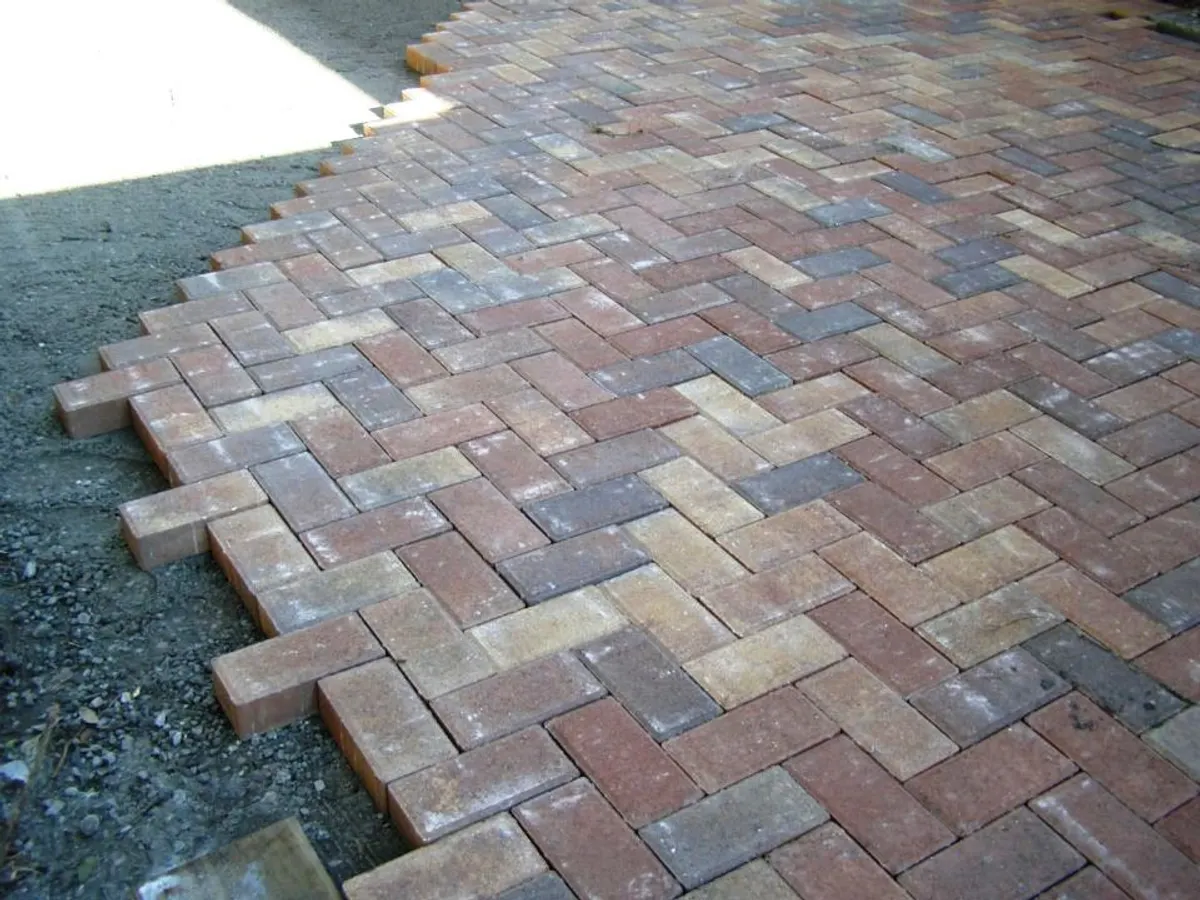 Herringbone block paving patio being laid