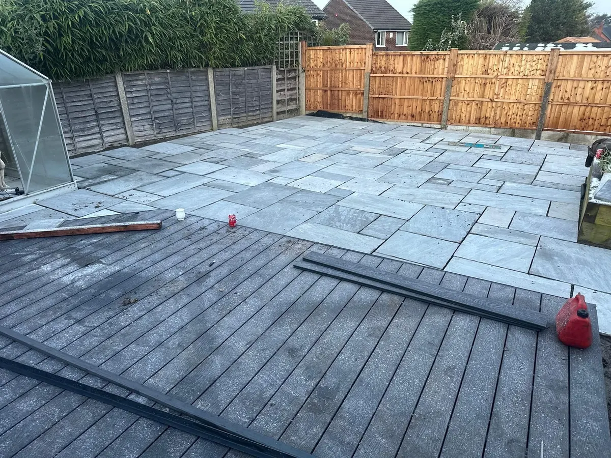 Composite decking being installed beside a new patio in Manchester