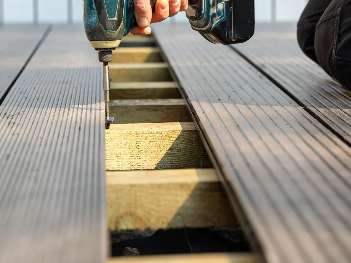 Composite deck boards being fixed to joists