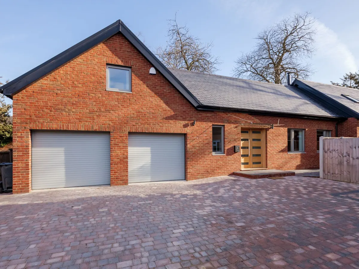 Brindle block paved driveway in front of a double garage