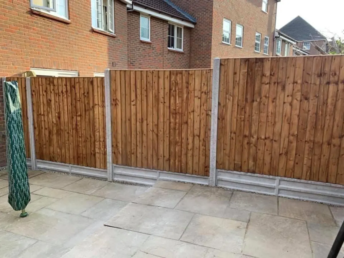 New closeboard fence with concrete posts above a patio in Manchester