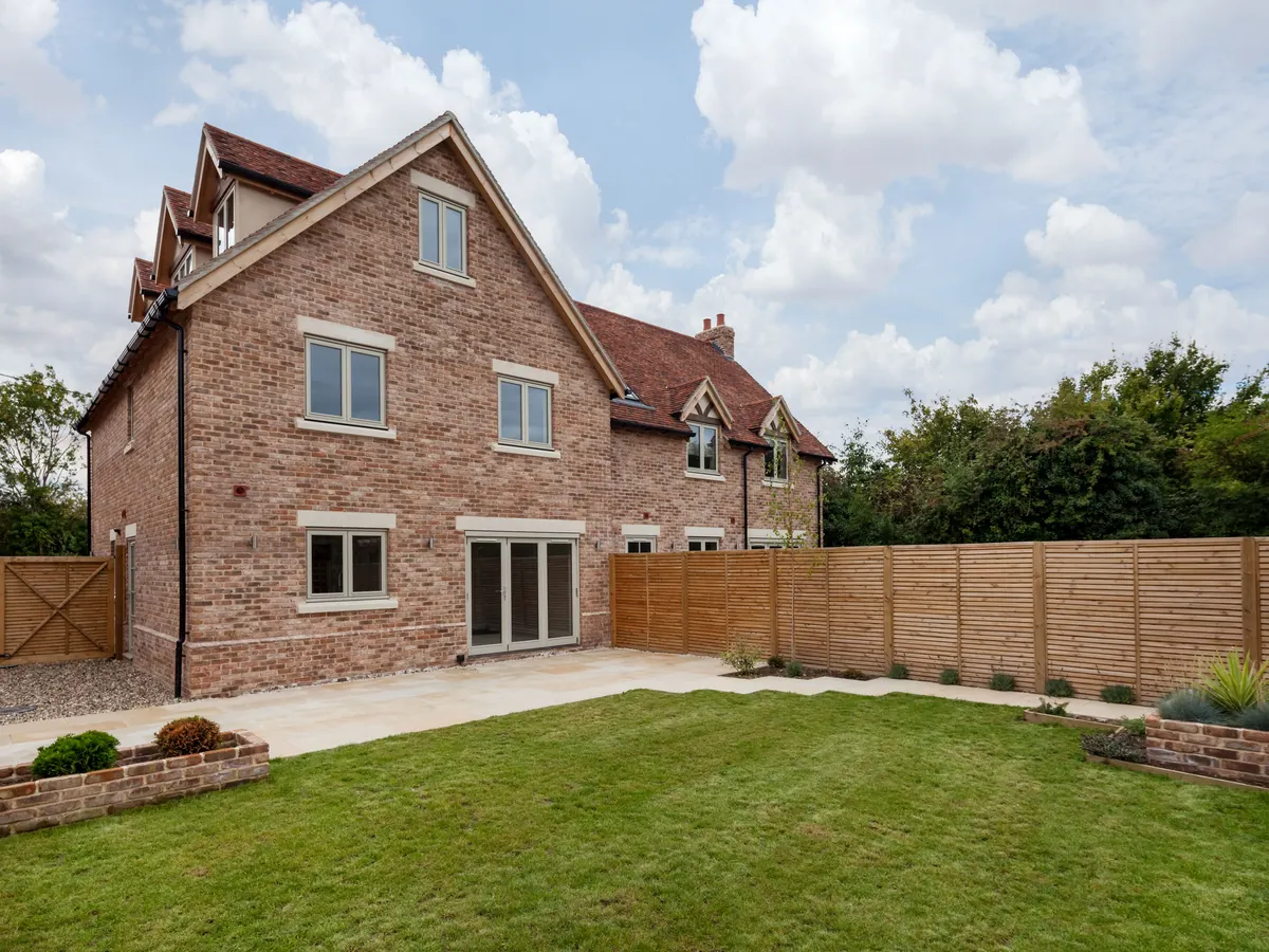 Landscaped rear garden with a lawn, patio and fencing