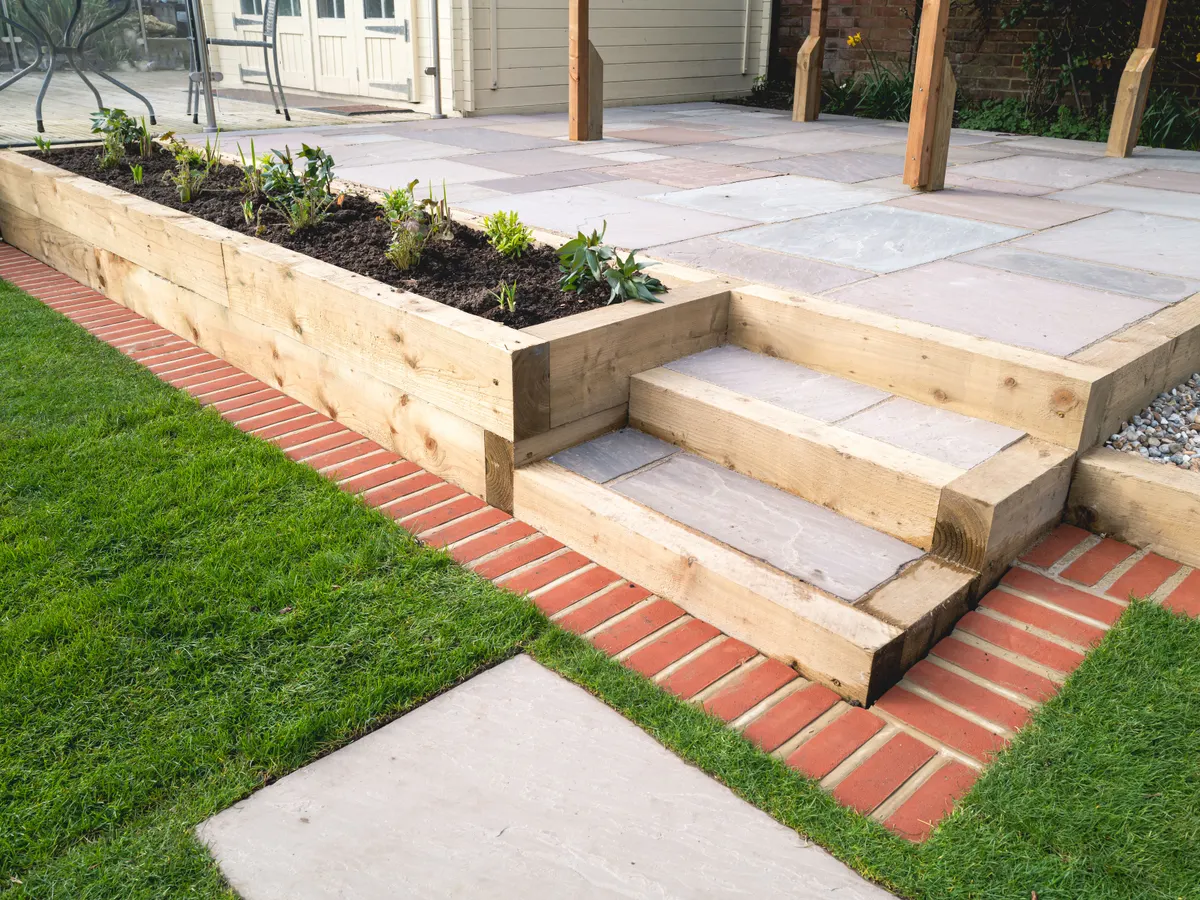 Sandstone and sleeper garden steps up to a patio