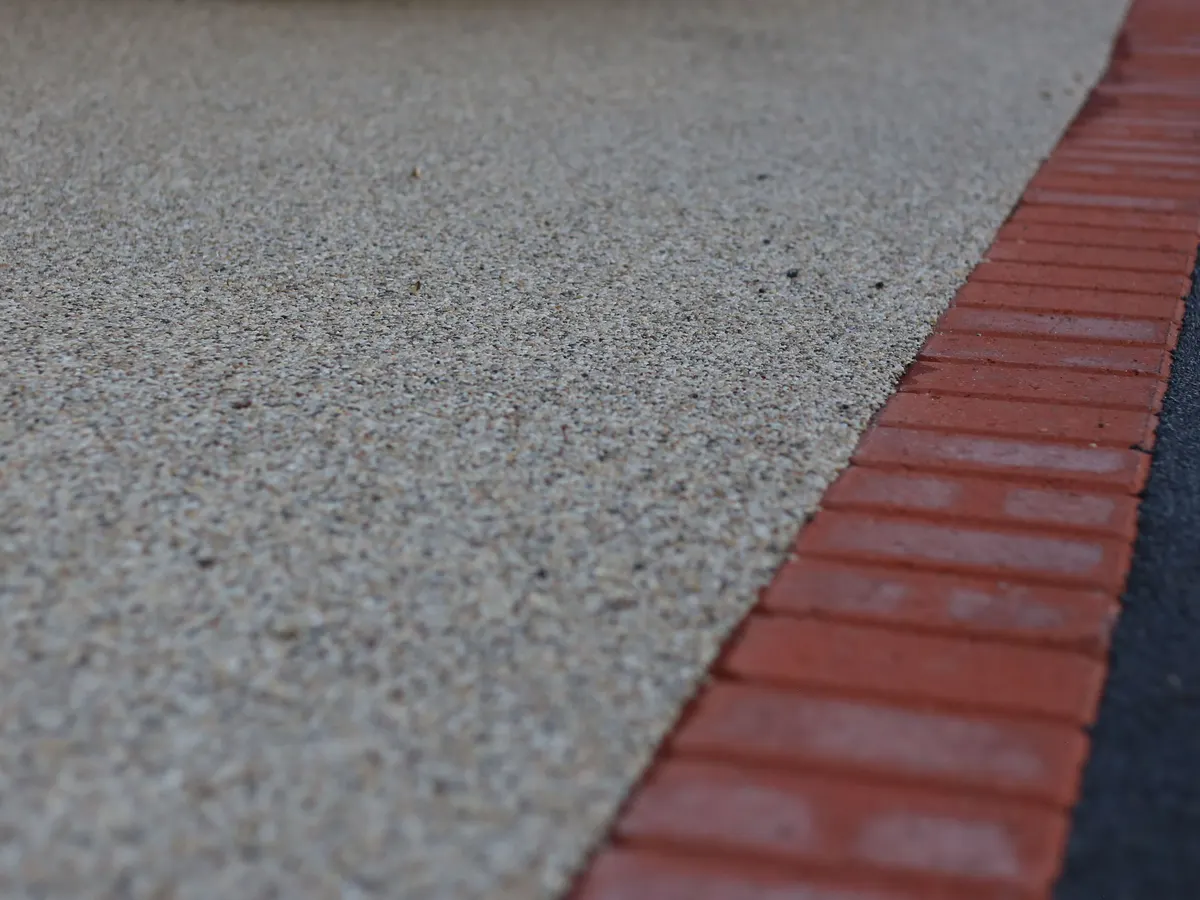 Resin bound driveway surface with a red block border