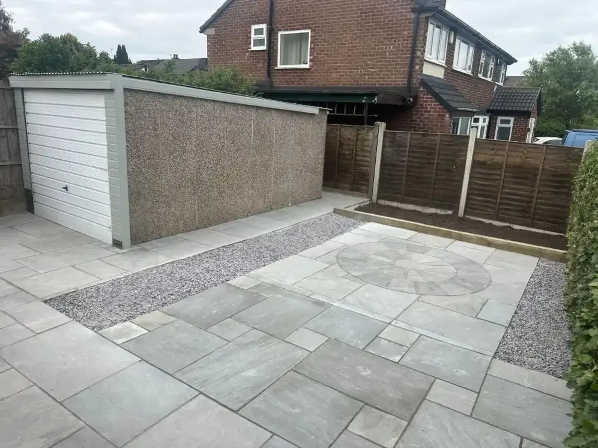 Grey sandstone patio with a circle feature and chipping borders in Manchester