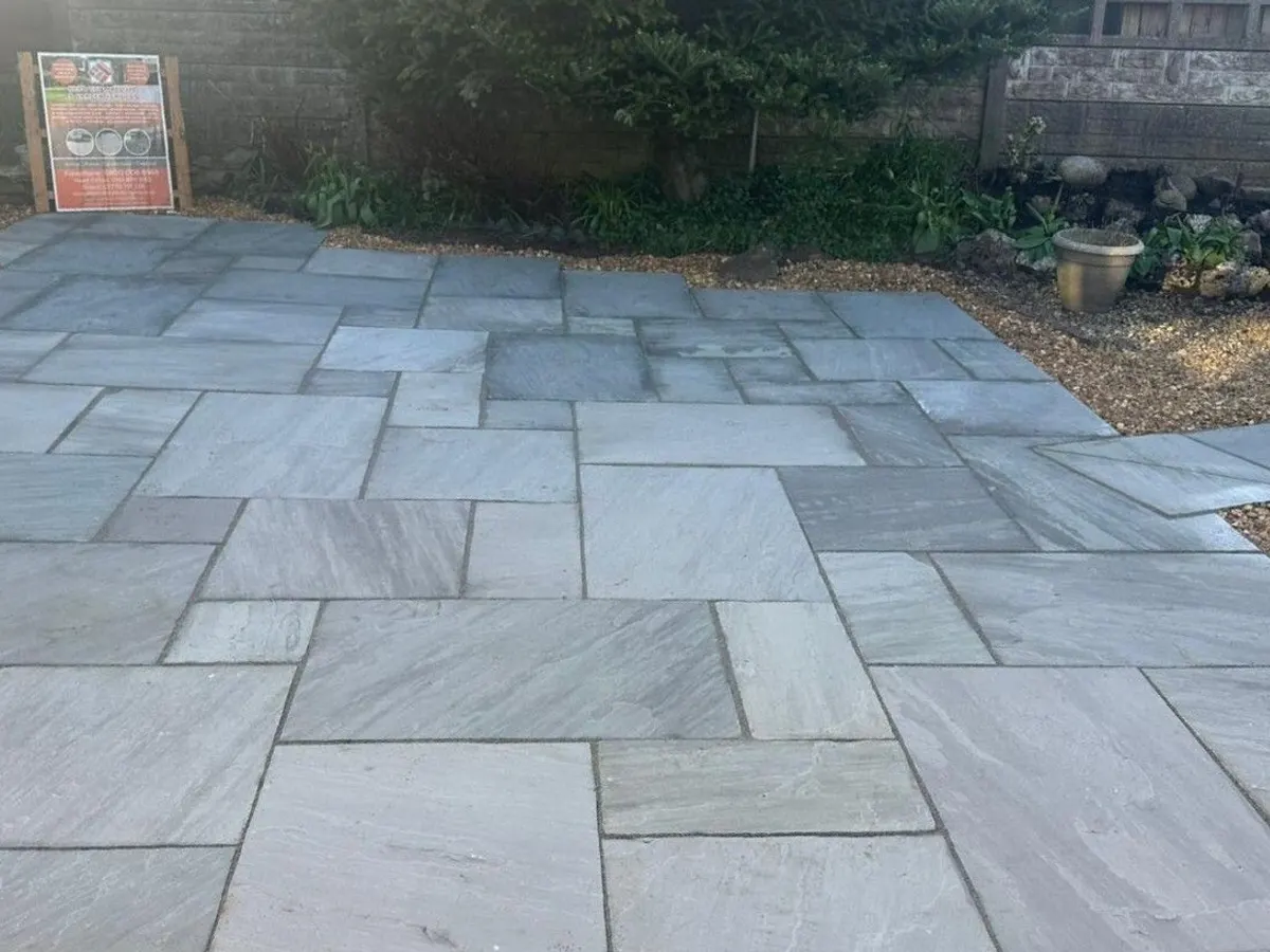 Grey riven sandstone patio with gravel edges in Manchester